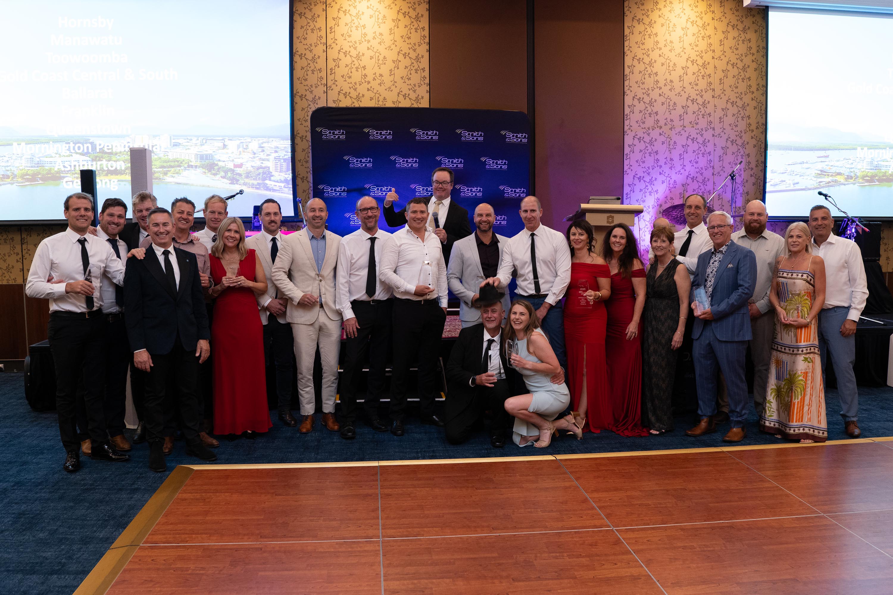 Franchise owners gathered on stage with their glass awards at the presentation night
